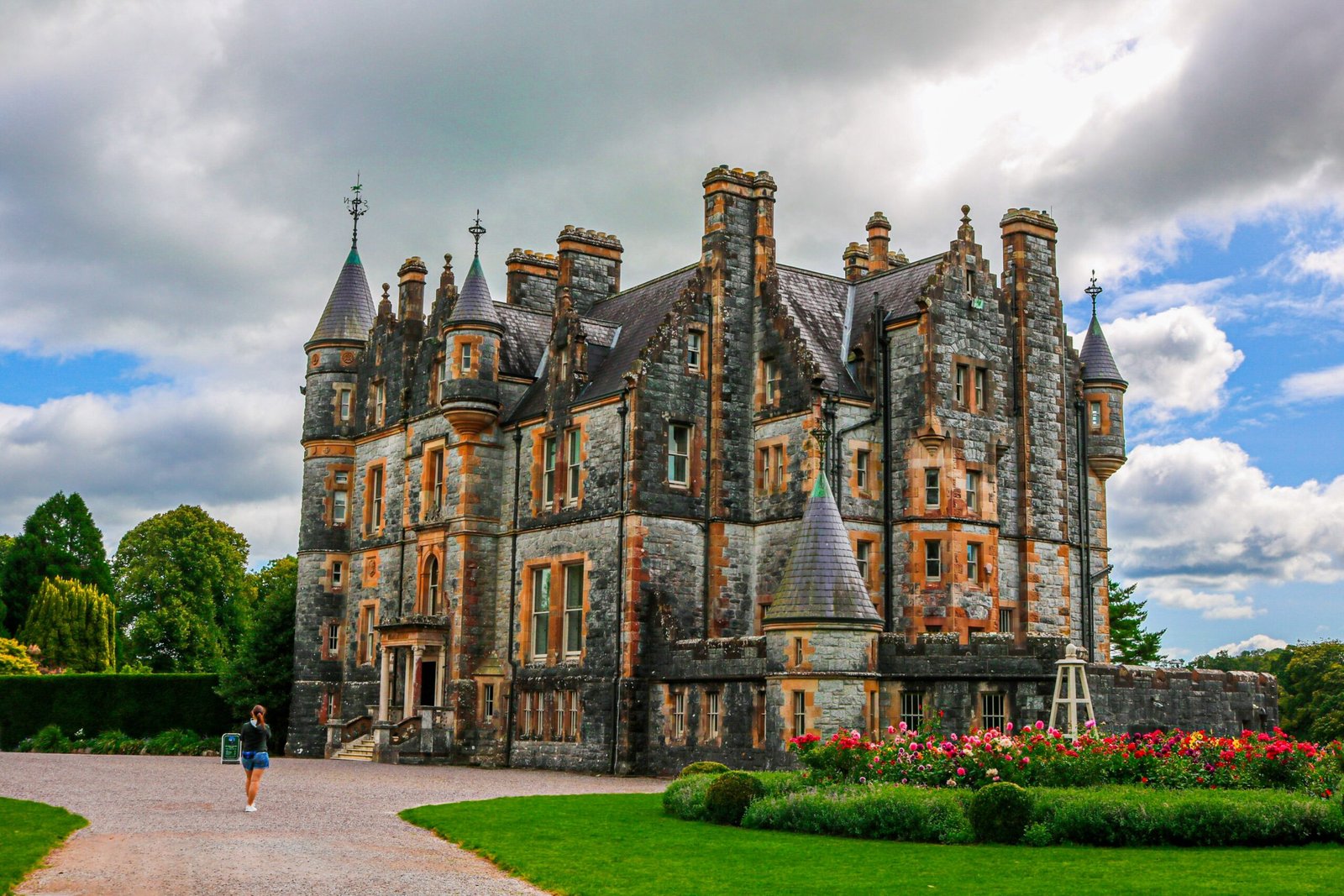 a large castle like building sitting on top of a lush green field